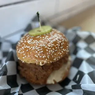 a burger with a pickle on top