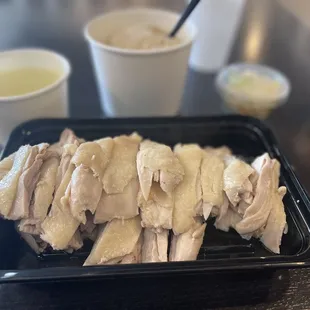 a tray of sliced chicken on a table