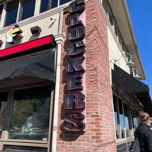 a woman walking past a restaurant