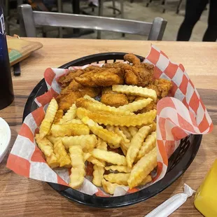a basket of fried chicken and fries