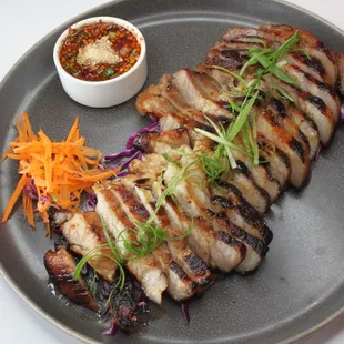 a plate of food with meat and vegetables