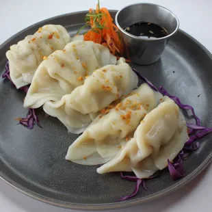 three dumplings on a plate