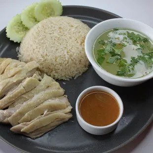 a plate of food with rice, meat, and sauce