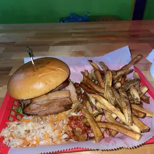 Pork Belly Sandwich with stuff on the side. Four meaty pieces of pork belly on a brioche bun. Fries are fan-tas-tic!!