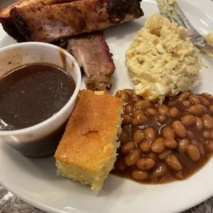 Half of two plates - ribs &amp; biscuits with beans, cornbread and potato salad