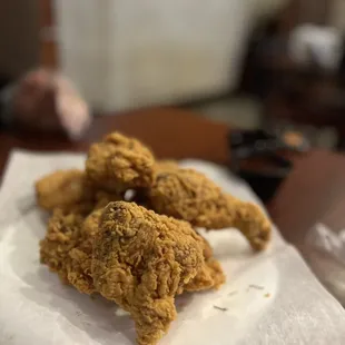 fried chicken on a napkin on a table