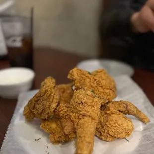 a pile of fried chicken on a napkin