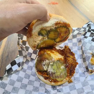 a hand holding a sandwich