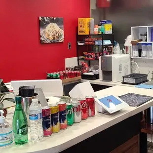 a kitchen with red walls and white counters
