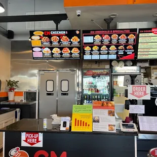 a counter with menus on the wall