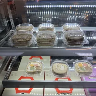 a display case filled with cupcakes