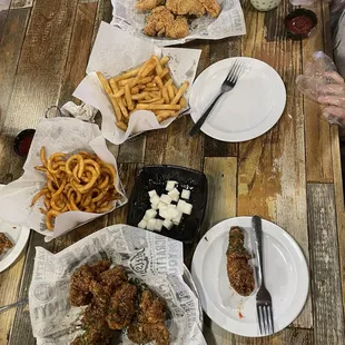a table of fried chicken and french fries