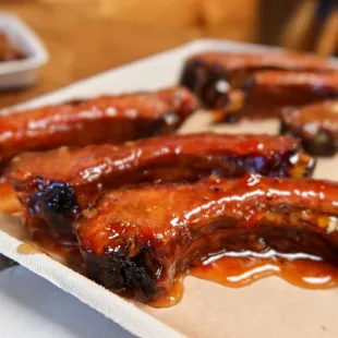 a tray of ribs with bbq sauce
