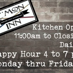 a brick wall with a sign that says kitchen open 11am to closing daily