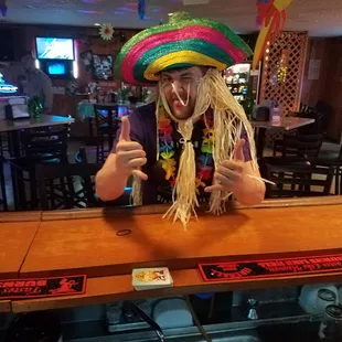 a man in a sombren at a bar