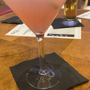 a pink drink in a martini glass