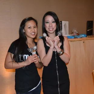 two women holding microphones