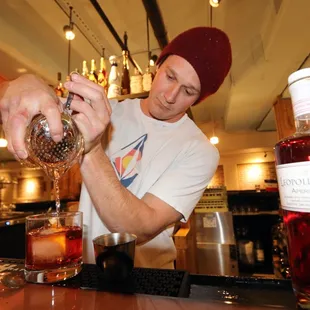Bartender at co. bar Frisco, Colorado pouring a drink