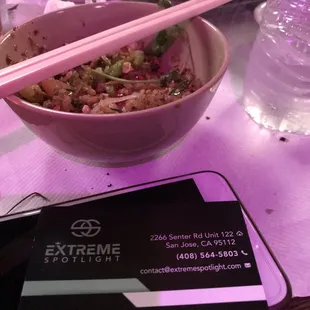 a bowl of food with chopsticks