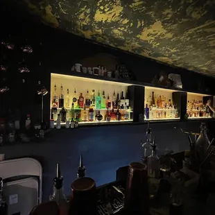 a bar with bottles of alcohol