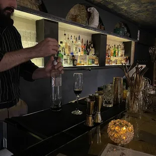 a bartender pouring a drink