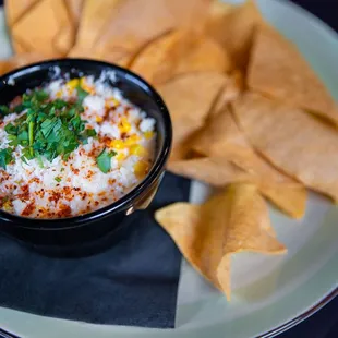 a bowl of dip with tortilla chips