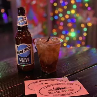 a beer and a drink on a table