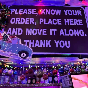 a sign that reads please know your order place here and move it along thank you