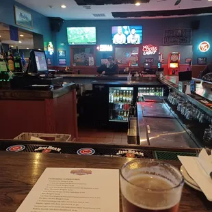 a pint of beer and a menu