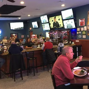 a group of people sitting at a bar