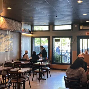 people sitting at tables in a restaurant