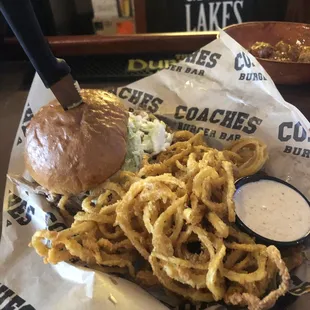 a basket of onion rings and a burger