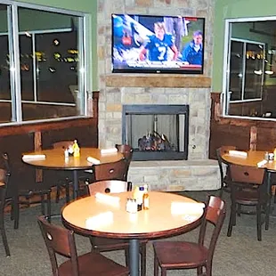 Private room with fireplace, multiple TV&apos;s, and small private patio enclosure.