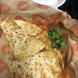 Three tiny pieces of lettuce that are wilted at the bottom