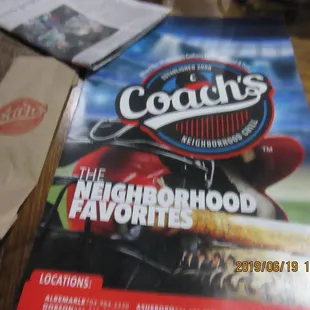 Coach’s Neighborhood Grill / Lexington: The initial setup: Menu and a fork in a paper wrapping.