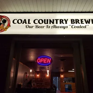 a neon sign above a doorway