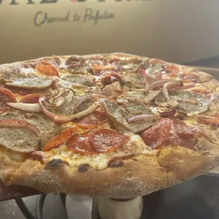 Sausage, pepperoni, and onion thin crust pizza.