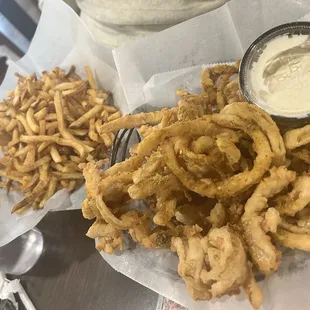 Huge serving of French fries and a delicious basket of onion rings (highly recommended)! The sauce that you see was delicious.