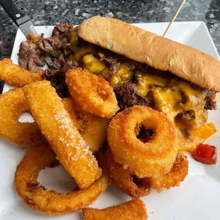 Shaved ribeye, sauteed onions, red peppers, and mushrooms w/American cheese.  Side of Onion Rings.