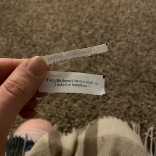 a hand holding a piece of paper