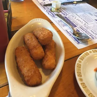 a bowl of soup and a plate of fried tater tots