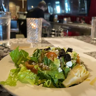 a plate of salad on a marble table