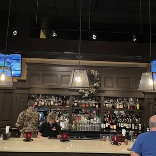 a man and a woman sitting at a bar