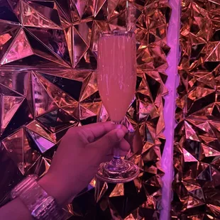 a person holding a glass of champagne