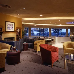 a living room with a fireplace and chairs