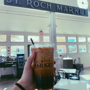 a hand holding a cup of coffee