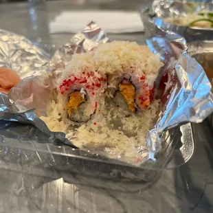 a piece of sushi wrapped in aluminum foil