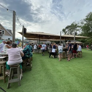 a large group of people sitting at outdoor tables