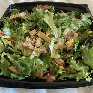 Mixed green salad with chicken.