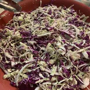 a bowl of coleslaw and pickles